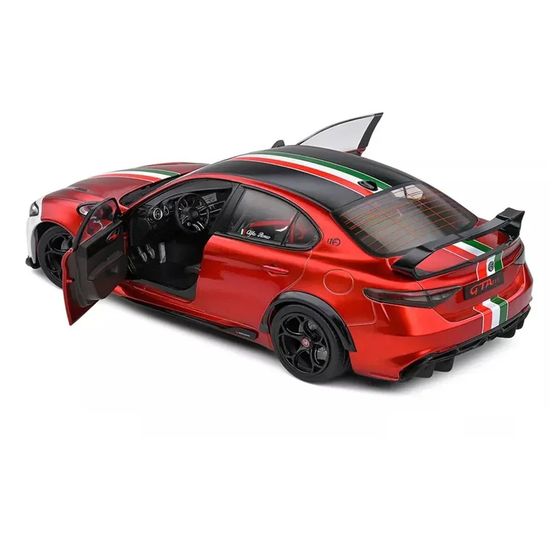 Red collectible toy sports car with open doors and Italian flag stripes on white background