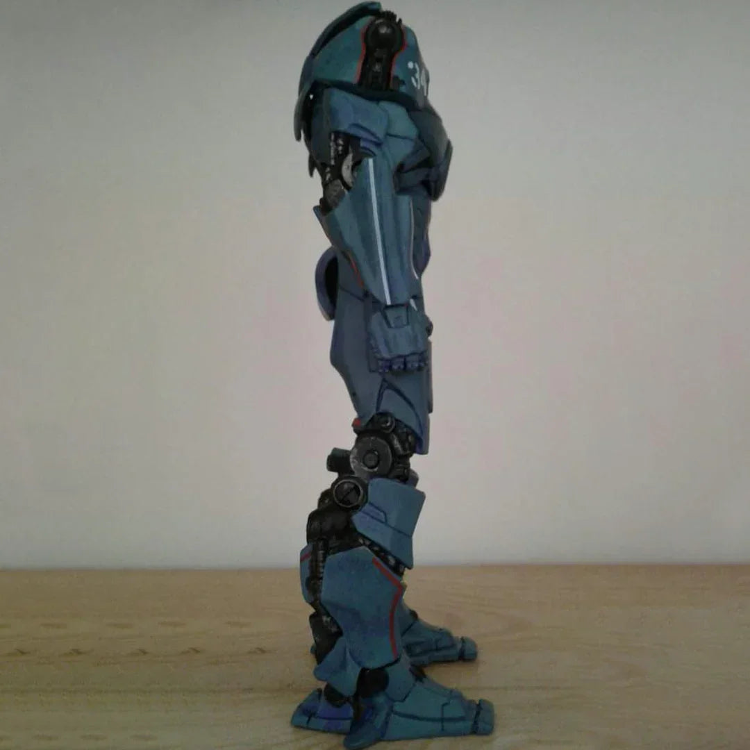 Blue robot action figure collectible standing sideways on a wooden surface