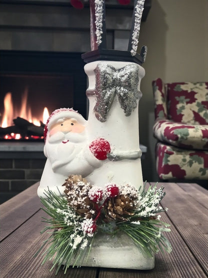 Snow Lantern Christmas Figurine Set | Santa & Snowman with Pinecones & Snowy Greens – Festive Table Décor Pack of 2