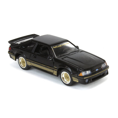GreenLight 1:64 Scale  1988 Ford Mustang Fox Body SLN – Black & Gold, LP Diecast Garage Exclusive